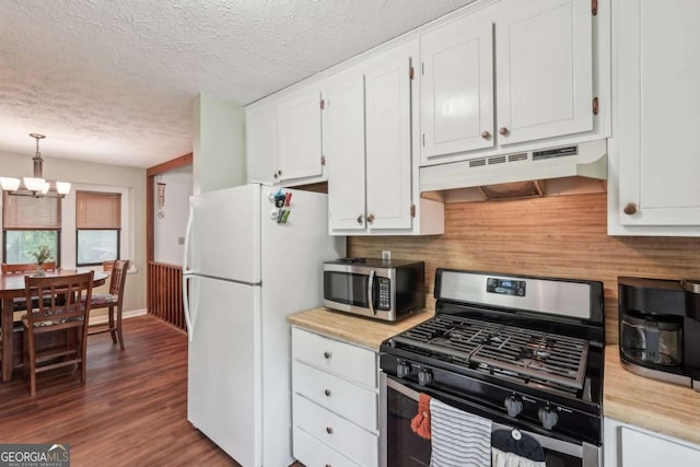 3679 Regent Dr NW, Kennesaw, GA 30144 - kitchen with white cabinets, an inviting chandelier, a textured ceiling, stainless steel appliances, and under cabinet range hood