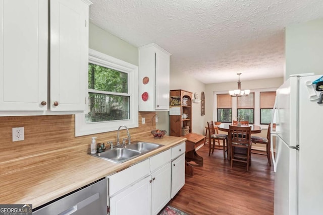 3679 Regent Dr NW, Kennesaw, GA 30144 - kitchen featuring a sink, freestanding refrigerator, white cabinetry, and a healthy amount of sunlight