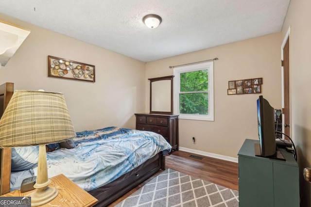 3679 Regent Dr NW, Kennesaw, GA 30144 - bedroom featuring baseboards, a textured ceiling, and dark wood-style floors