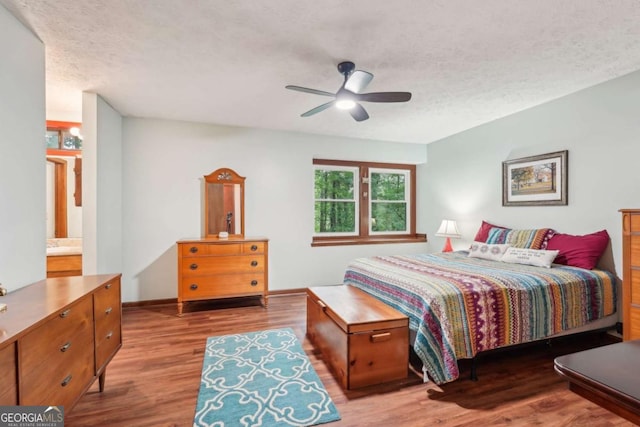 3679 Regent Dr NW, Kennesaw, GA 30144 - bedroom featuring a textured ceiling, ceiling fan, and wood finished floors