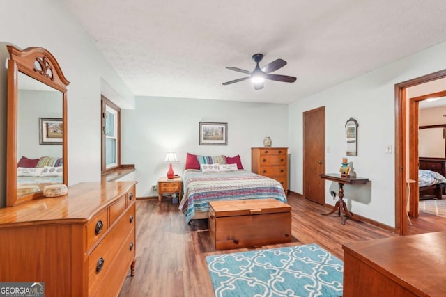 3679 Regent Dr NW, Kennesaw, GA 30144 - bedroom featuring a ceiling fan, baseboards, and light wood-style flooring