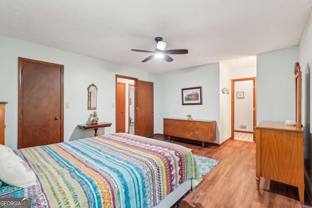 3679 Regent Dr NW, Kennesaw, GA 30144 - bedroom with baseboards, ceiling fan, and light wood-style flooring