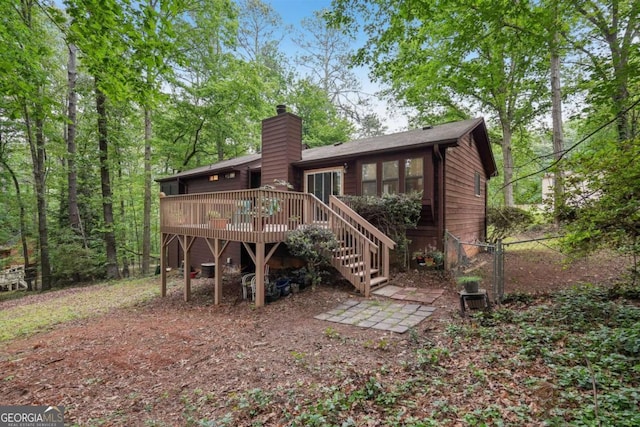3679 Regent Dr NW, Kennesaw, GA 30144 - back of property featuring stairway, a wooden deck, a chimney, and fence