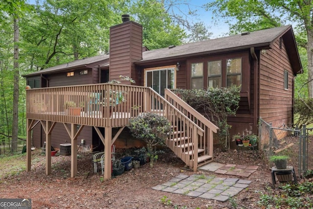 3679 Regent Dr NW, Kennesaw, GA 30144 - rear view of property with fence, a wooden deck, and a chimney