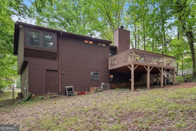 3679 Regent Dr NW, Kennesaw, GA 30144 - rear view of house featuring a chimney, central AC unit, fence, and a wooden deck