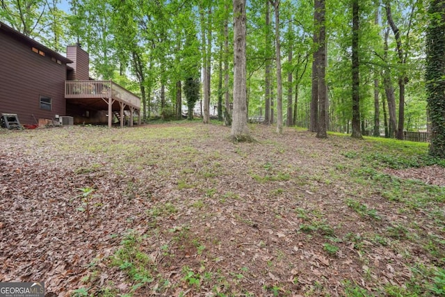 3679 Regent Dr NW, Kennesaw, GA 30144 - view of yard featuring a wooden deck and central AC