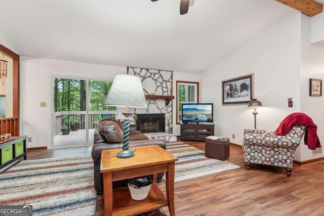 3679 Regent Dr NW, Kennesaw, GA 30144 - living room featuring a fireplace, a ceiling fan, baseboards, wood finished floors, and lofted ceiling