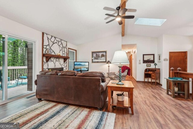 3679 Regent Dr NW, Kennesaw, GA 30144 - living area with ceiling fan, lofted ceiling with skylight, and light wood-style floors