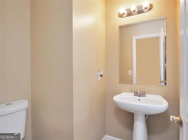 145 Tara Way, Covington, GA 30016 - bathroom featuring toilet and a sink