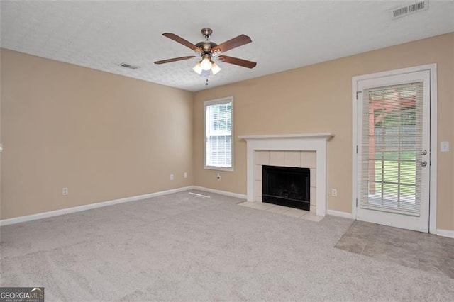 145 Tara Way, Covington, GA 30016 - unfurnished living room featuring carpet floors, a ceiling fan, and a tiled fireplace