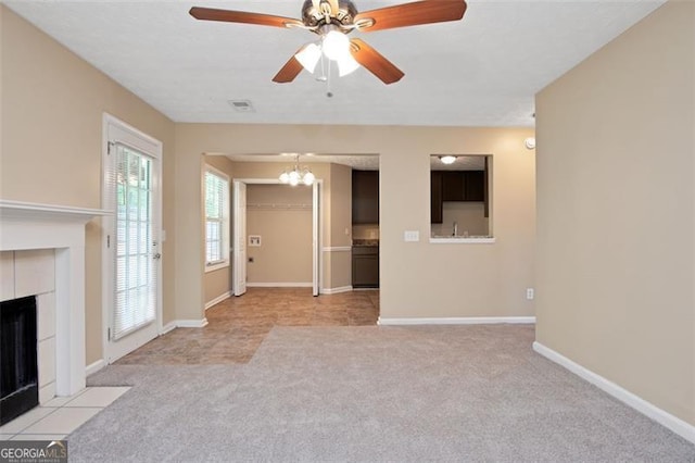 145 Tara Way, Covington, GA 30016 - unfurnished living room featuring light carpet, a fireplace, a chandelier, and a ceiling fan