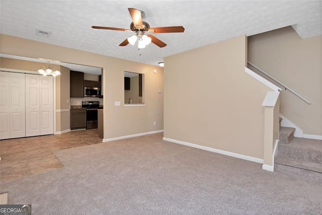 145 Tara Way, Covington, GA 30016 - unfurnished living room with light carpet, a ceiling fan, stairs, a textured ceiling, and a chandelier