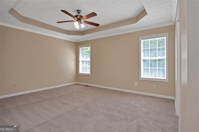 145 Tara Way, Covington, GA 30016 - unfurnished room featuring a tray ceiling, a ceiling fan, light colored carpet, crown molding, and a textured ceiling