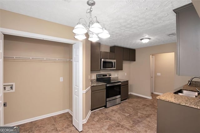 145 Tara Way, Covington, GA 30016 - kitchen with stainless steel appliances, hanging light fixtures, light stone countertops, a textured ceiling, and dark brown cabinetry