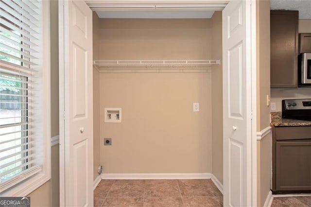 145 Tara Way, Covington, GA 30016 - laundry room with electric dryer hookup, washer hookup, and light tile patterned flooring