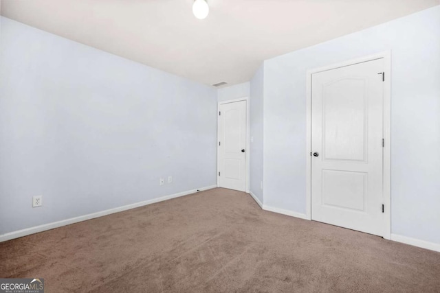 unfurnished bedroom with carpet floors and baseboards