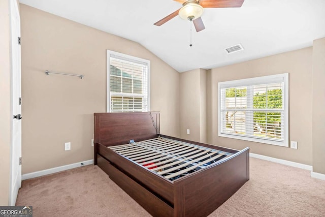 bedroom featuring baseboards, visible vents, lofted ceiling, and carpet