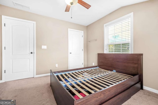 bedroom featuring baseboards, carpet, a ceiling fan, and visible vents