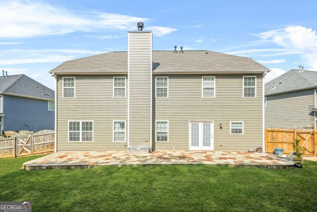 rear view of house featuring a lawn, a gate, a patio, and a fenced backyard