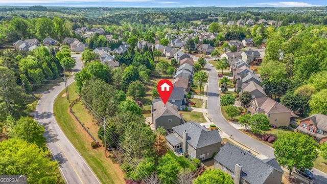 drone / aerial view with a residential view and a view of trees