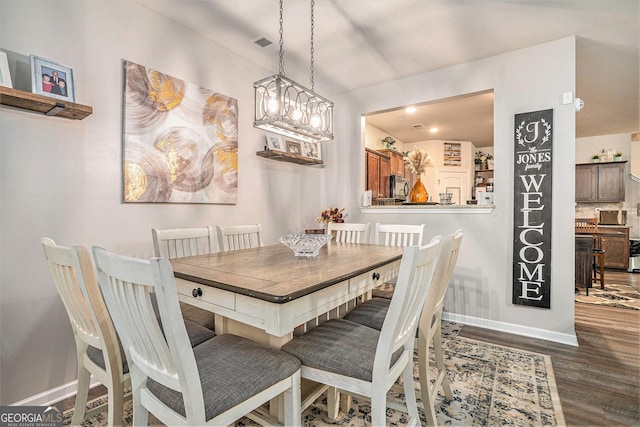 dining area with baseboards, dark wood-style flooring, and visible vents