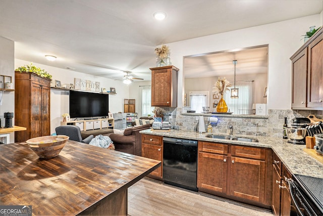 kitchen featuring a sink, tasteful backsplash, wood counters, and dishwasher