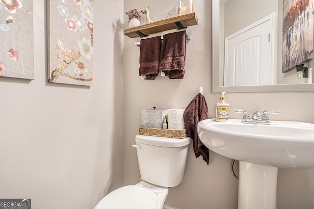 bathroom featuring toilet and a sink