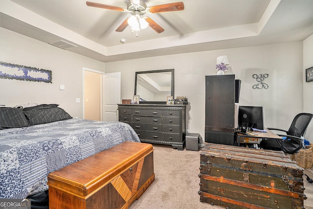 bedroom with visible vents, a raised ceiling, ceiling fan, and carpet floors