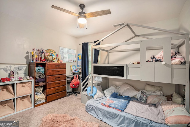 carpeted bedroom featuring ceiling fan and visible vents