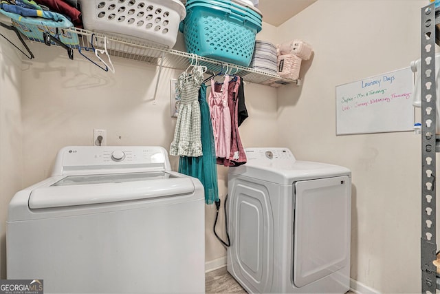 laundry room with washer and dryer, laundry area, and baseboards