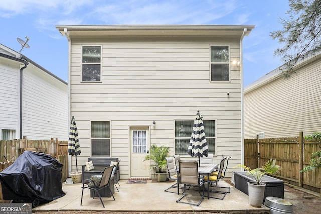 back of house featuring a patio area and a fenced backyard