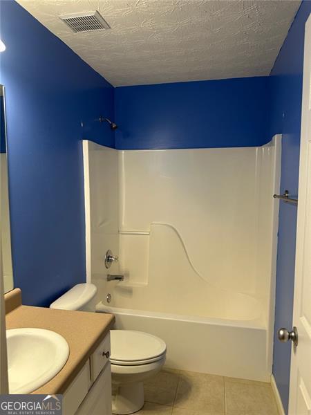 3218 Watson Woods Way, Loganville, GA 30052 - bathroom featuring visible vents, tile patterned flooring, vanity, toilet, and shower / bathtub combination