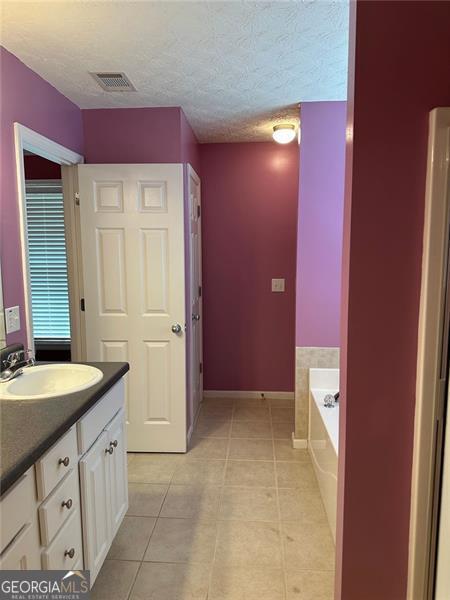 3218 Watson Woods Way, Loganville, GA 30052 - bathroom featuring visible vents, tile patterned flooring, vanity, toilet, and shower / bathtub combination