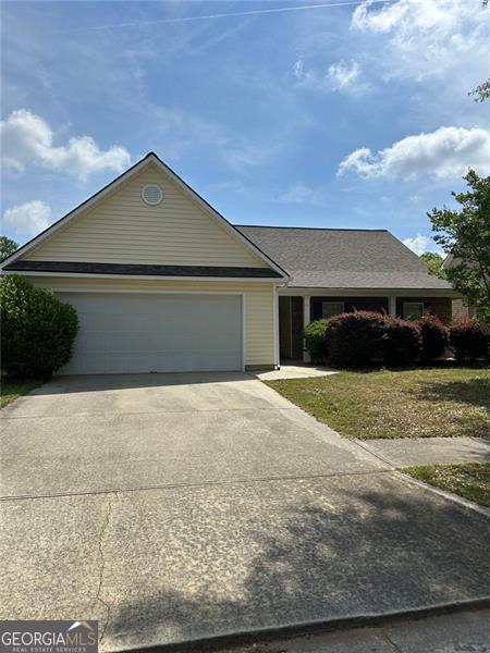 3218 Watson Woods Way, Loganville, GA 30052 - ranch-style house with an attached garage, driveway, and a front yard