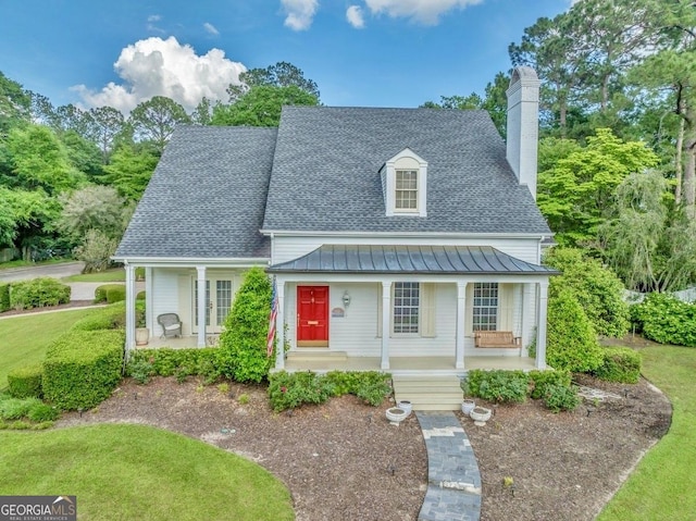 view of front of home featuring covered porch, a standing seam roof, and roof with shingles