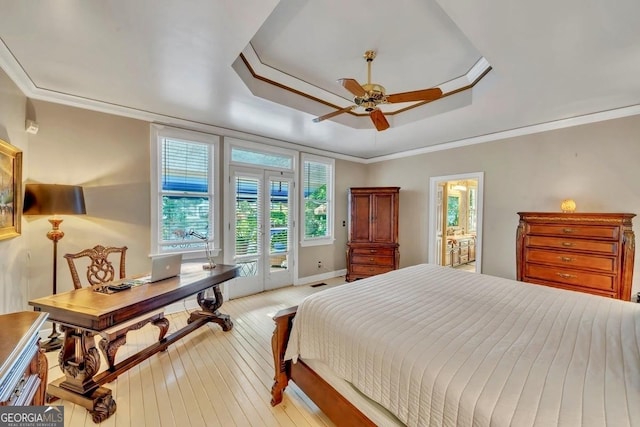 bedroom featuring access to exterior, baseboards, ceiling fan, a tray ceiling, and light wood-style flooring
