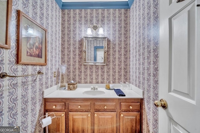 bathroom featuring vanity and wallpapered walls