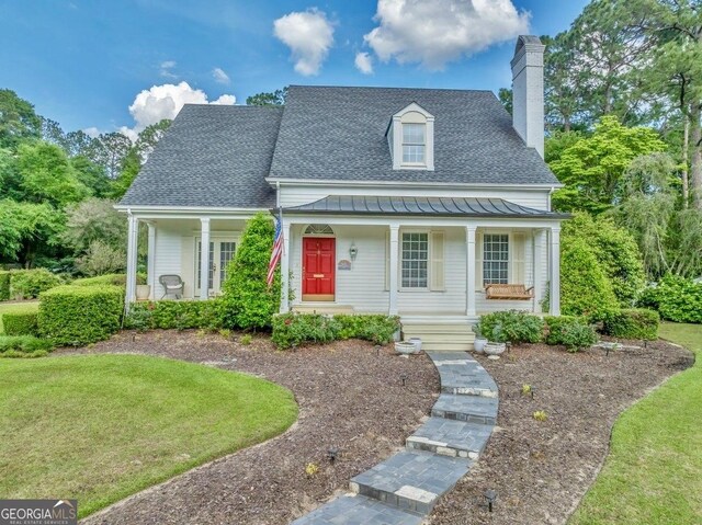 113 Quinn Dr, Dublin, GA 31021 - view of front facade with a standing seam roof, covered porch, a shingled roof, and metal roof