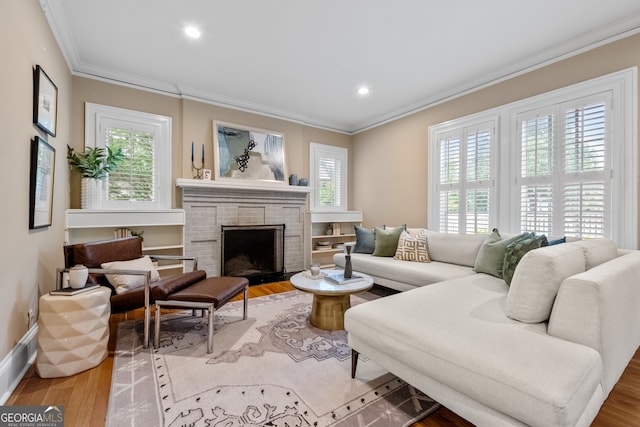 living room featuring ornamental molding, a wealth of natural light, and wood finished floors