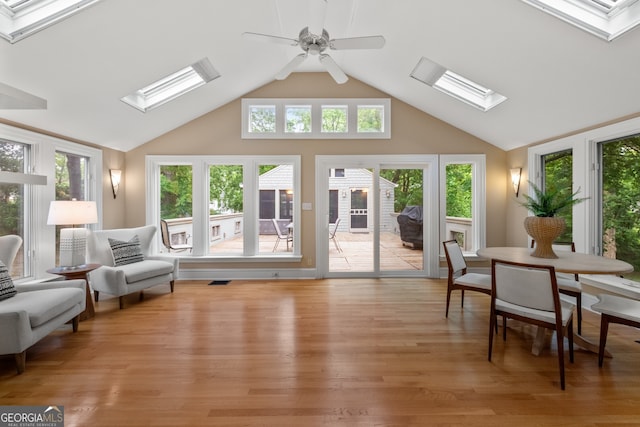 sunroom featuring a skylight and a wealth of natural light