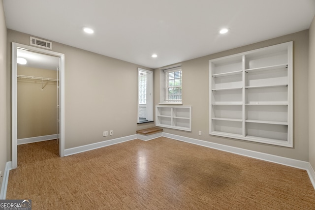 unfurnished bedroom featuring visible vents, recessed lighting, baseboards, and a spacious closet