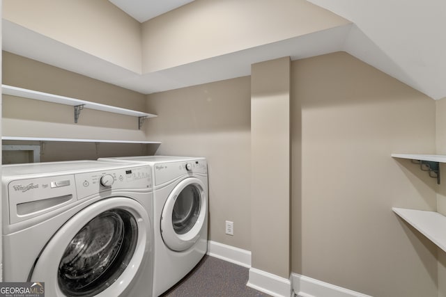 washroom featuring baseboards, laundry area, and washer and clothes dryer
