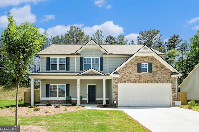 496 River Run Dr, Dallas, GA 30132 - craftsman-style house with stone siding, concrete driveway, a porch, and an attached garage