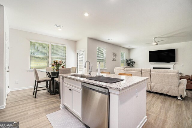 496 River Run Dr, Dallas, GA 30132 - kitchen featuring dishwasher, a sink, light wood-style floors, a center island with sink, and white cabinets
