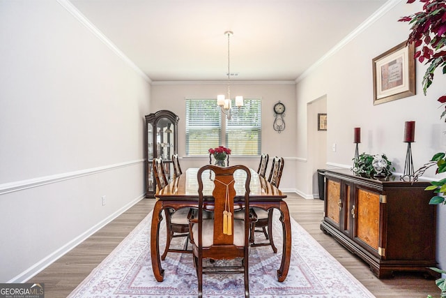 496 River Run Dr, Dallas, GA 30132 - dining room featuring a chandelier, light wood-style flooring, ornamental molding, and baseboards