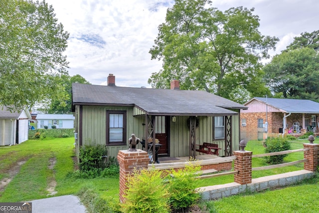 157 Hartwell St, Royston, GA 30662 - view of front of home featuring board and batten siding, a chimney, and a front lawn