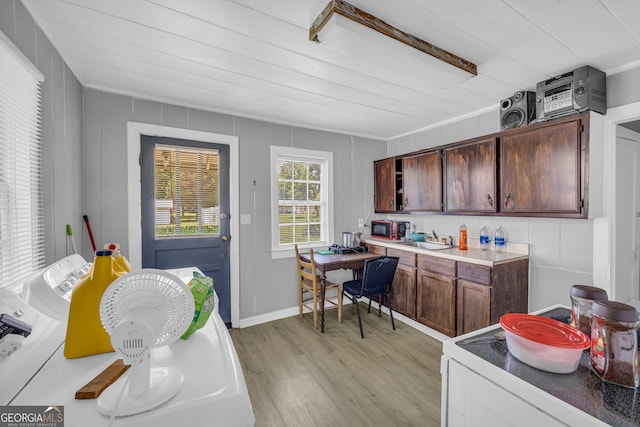 157 Hartwell St, Royston, GA 30662 - kitchen with dark brown cabinetry, a sink, light wood finished floors, light countertops, and ornamental molding