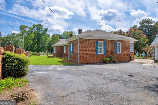 157 Hartwell St, Royston, GA 30662 - view of home's exterior with a yard, brick siding, and a chimney