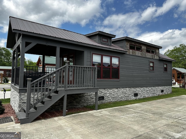 exterior space featuring metal roof and crawl space