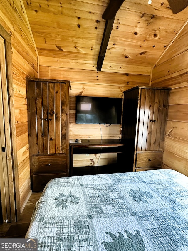 bedroom with wood ceiling, vaulted ceiling, wood walls, and wood finished floors